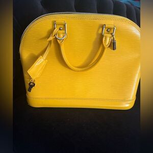 Used excellent condition Louis Vuitton  Epi Alma BB  with strap